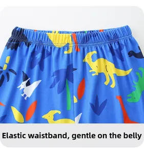 Detailed macro shot of elastic waistband on bright blue dinosaur print kids pajamas