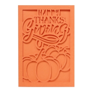 Detail of laser-cut orange Thanksgiving card with pumpkin and Happy Thanksgiving text