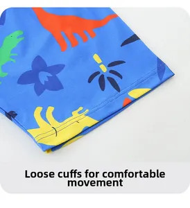 Close-up of loose-fit cuffs on blue dinosaur print boys' summer shorts set with stitching