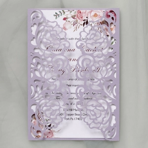 Detail showing lavender laser-cut floral wedding invitation with floral printed inner card