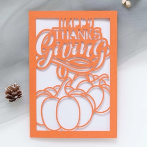 Laser-cut Happy Thanksgiving card featuring hollow pumpkins and orange paper design