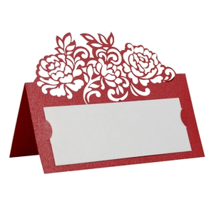Macro shot of red laser-cut rose floral table place card with elegant hollow design