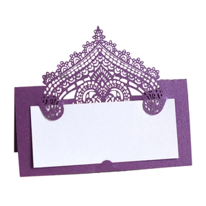 Detailed view of purple laser-cut lace wedding place card with white inner insert