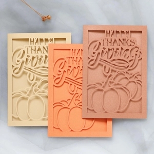 Close-up of laser-cut pumpkin and Happy Thanksgiving text on premium shimmer paper