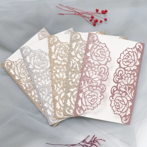 Detailed laser-cut rose patterns on glitter wedding invitation cards in multiple colors
