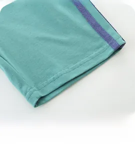 Close-up of teal knit shorts leg opening with purple side stripe and twin-needle stitching