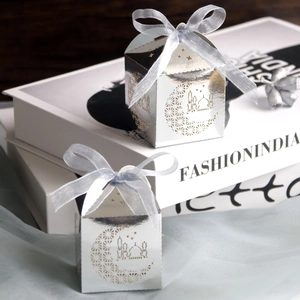 Silver hollow moon candy boxes with blue ribbons for party favors and gift packaging