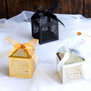Hollow star moon party candy boxes in gold, silver, and black with ribbon bows