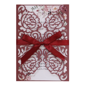 Elegant laser-cut burgundy wedding invitation with rose hollow design and a silk bow