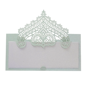 Macro detail of laser-cut lace pattern on light blue pearlescent paper place card