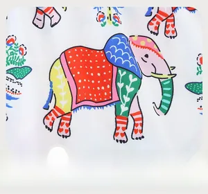 Detailed view of colorful cartoon elephant prints on premium cotton fabric for girls' dress
