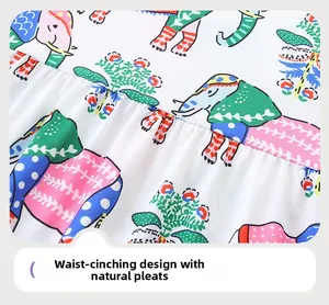 Close-up of waist design with 3D pleated details and colorful elephant print on fabric