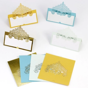 Laser-cut lace place cards in gold, blue, green, and yellow shown flat and folded