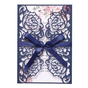 Elegant navy blue laser cut wedding invitation with floral sleeve and silk ribbon bow