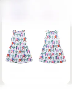 Flat lay detail of girl's white cotton dress with colorful elephant and floral patterns