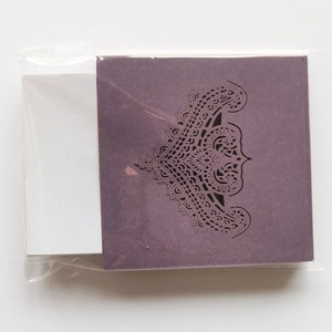Detailed laser-cut purple lace wedding place card with elegant hollow pattern design