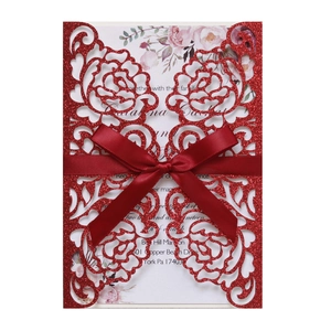 Elegant red glitter laser cut wedding invitation with a satin bow and floral inner card