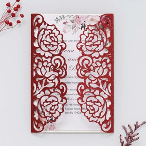 Detail of red glitter laser-cut rose wedding invitation with elegant floral inner card
