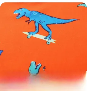 Detail of creative blue dinosaur skating print on premium orange cotton fabric texture