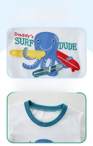 Detail showing high-quality embroidery of octopus and surfboards on a boys' cotton T-shirt