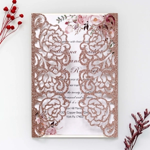 Detail showing laser-cut rose hollow glitter cover with floral wedding invitation card