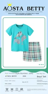 Detail of boys' cotton t-shirt with whale print and plaid shorts showing fabric texture
