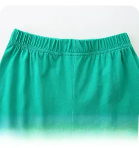 Detail of elastic waistband on green cotton shorts with soft texture and premium stitching