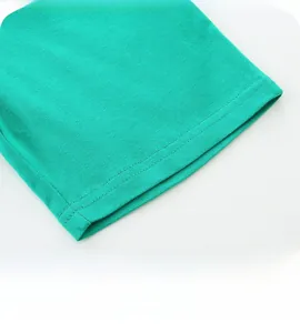 Close-up of vibrant green cotton shorts leg with durable double-needle stitching detail