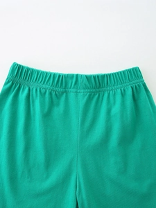 Close-up of emerald green cotton knit shorts with elastic waistband for kids' summer sets