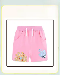 Detail of pink cotton shorts with elastic waistband and floral embroidery patches
