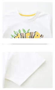 Detail of white cotton kids T-shirt featuring a yellow neck piping and cartoon print