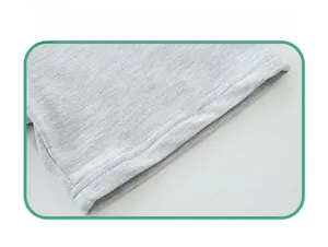 Detail shot of grey knit shorts hem featuring high-quality double-needle flat stitching