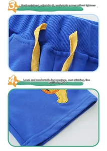 Detail of blue boys shorts showing elastic drawstring waist and embroidery stitching