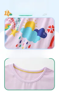 Detail of pink cotton girl's top with cartoon prints and reinforced crew neckline