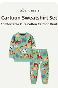 Close-up of mint green cotton set featuring cartoon farm animals and tractor prints