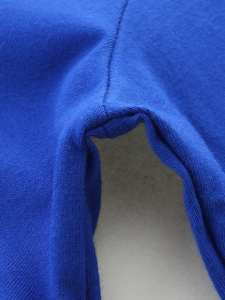 Close-up of durable stitching on a royal blue long-sleeve knit cotton dress for girls