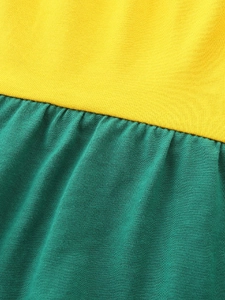 Long-sleeved girl's knit cotton dress featuring a yellow and dark green color-block design