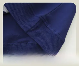 Close-up of the high-density ribbed hem and neat double stitching on dark blue knitwear
