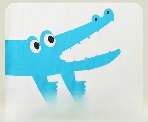 Detail of blue cartoon crocodile print on white cotton long sleeve boys' t-shirt