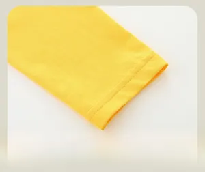 Detailed close-up of lemon yellow kids long sleeve t-shirt sleeve with flat seam stitching