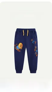 Detail of navy cotton kids joggers featuring lion embroidery and ribbed cuffs