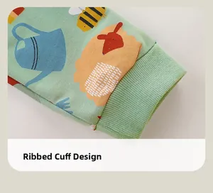 Detail of ribbed cuffs on mint green kids long sleeve set with cute animal prints