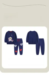 Detail view of navy blue cotton kids outfit featuring cartoon dragon and heart patch