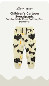 Detail of boys Halloween sweatpants featuring black bats, yellow moons and cotton fabric