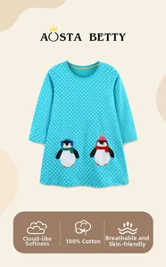 Detail of 100% cotton blue polka dot dress with cute penguin embroidery and soft fabric