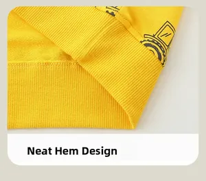 Close-up of bright yellow sweatshirt ribbed hem with car print and neat stitching