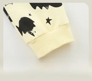 Detail of ribbed elastic cuffs on boys' Halloween pants with bat and star patterns
