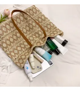 Spacious interior of woven straw tote bag filled with a laptop and daily essentials