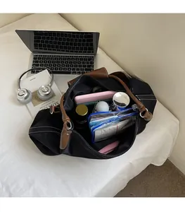 Interior view of large black nylon tote bag showing spacious capacity for travel essentials