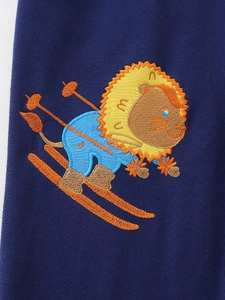 Kids navy blue sports pants featuring a detailed cartoon lion embroidery skiing pattern